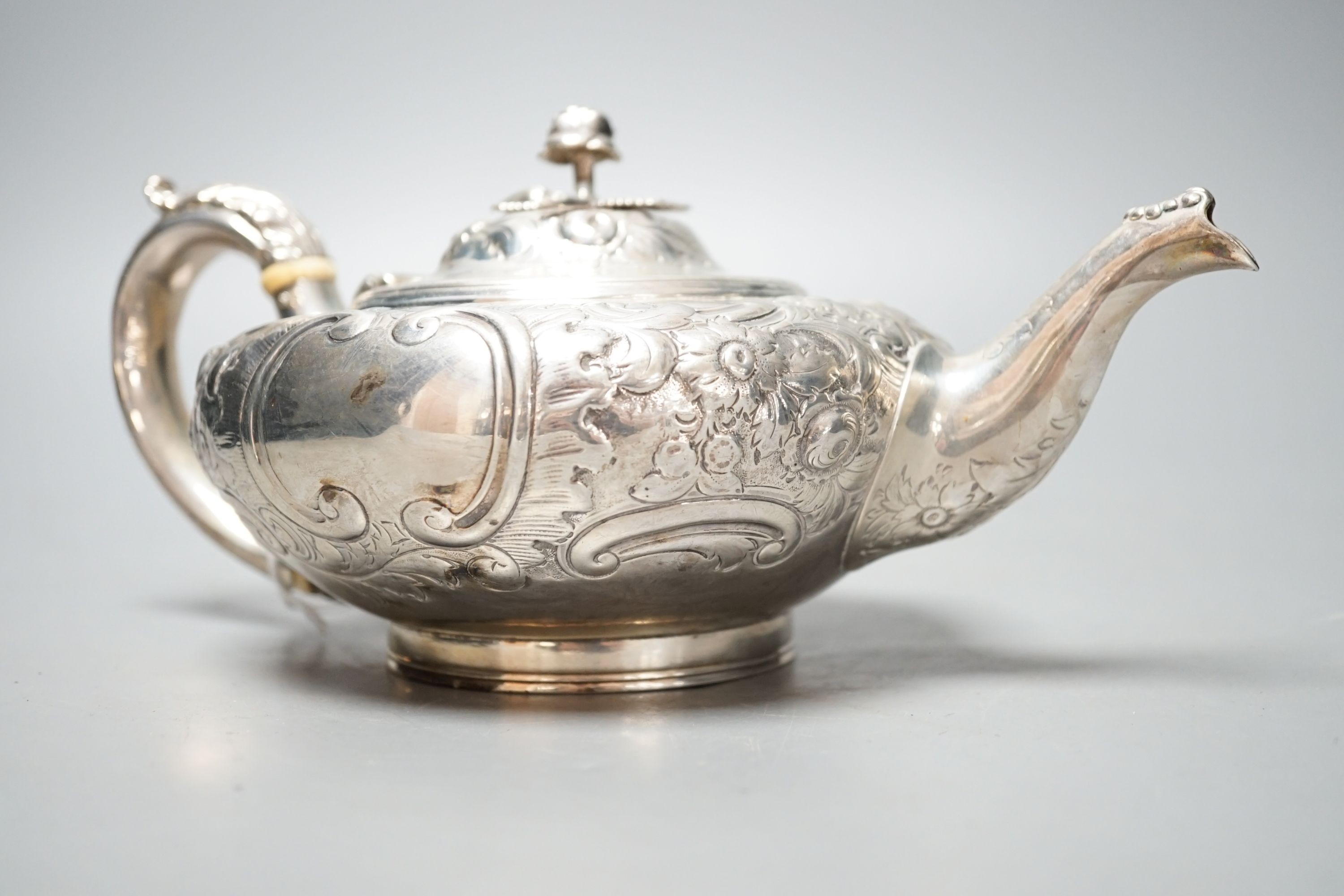 A Victorian embossed silver teapot, Walter Morrise, London, 1842, gross 15.5oz.